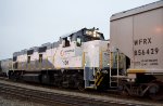 NREX 101 GenSet, pushing a string of 25 loaded, covered hopper grain cars towards the grain terminal in Brownsville.